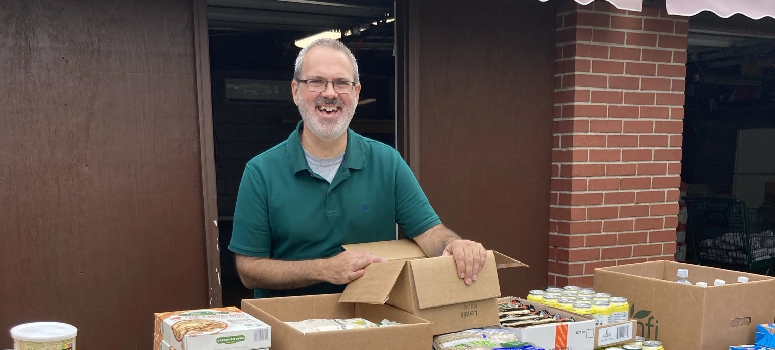 Father Ed serving food to poor families in Providence RI