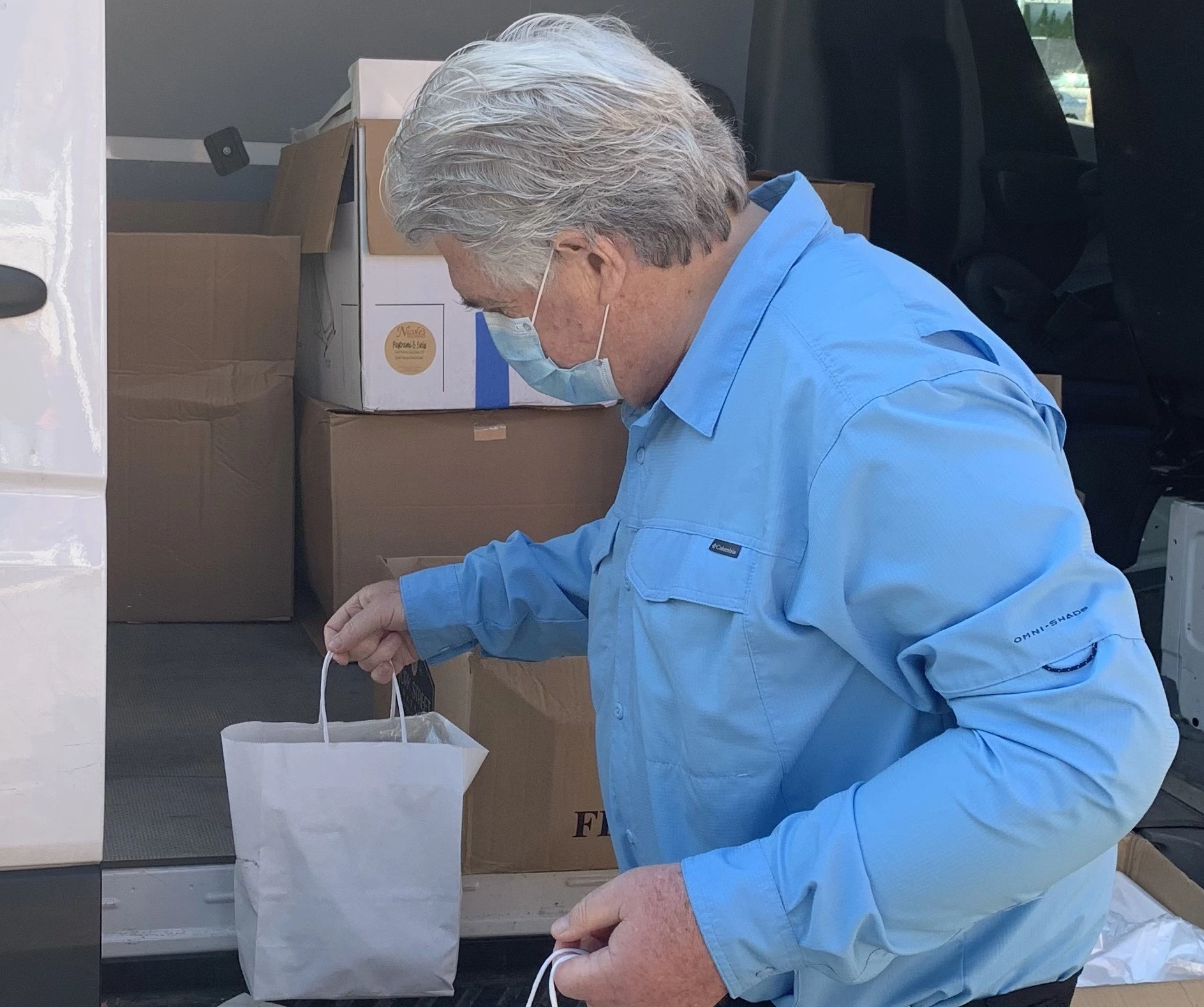 man unloading food truck in Providence RI for donation to homeless people